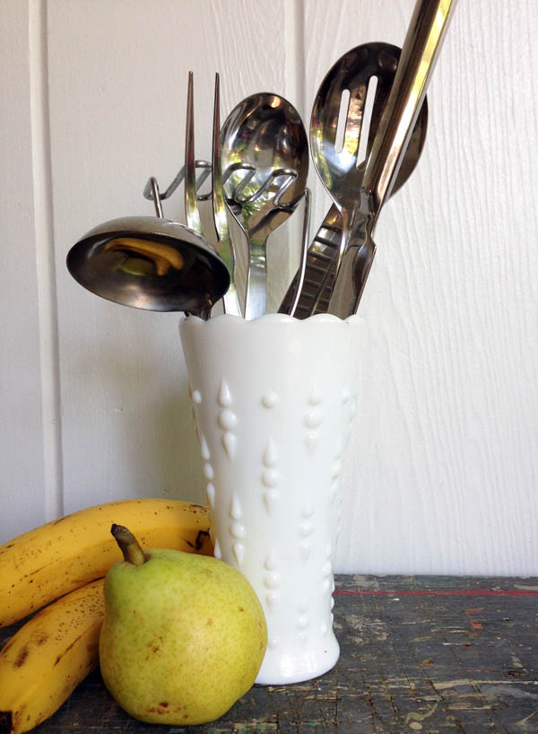 Milk glass vase with utensils