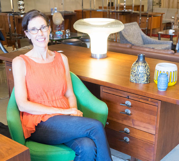 Jennifer Sams, owner of City Issue midcentury modern boutique in Atlanta; Lesbo lamp; Jens Risom walnut desk; photo by Finely Crafted